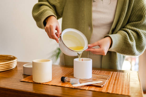 young woman making scented soy candles for her small business